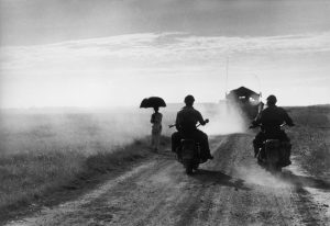 INDOCHINA (VIETNAM). May 25th, 1954. Motorcyclists and woman walking on the road from Nam Dinh to Thai Binh.