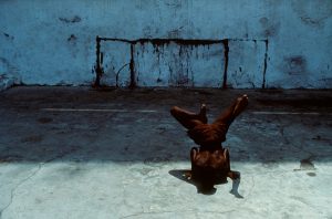 Salvador de Bahia. Boy dancing the "Capoeira". The Capoiera is an Afro-Brazilian martial art with dance like acrobatic movements that are combined with music and song. It is originates from the slaves arriving in Brazil from Africa during the Portuguese colonization in the 16th century; it was forbidden to them to be trained for the fight so the slaves camouflaged their practices behind the song, the music and the movements of dance.